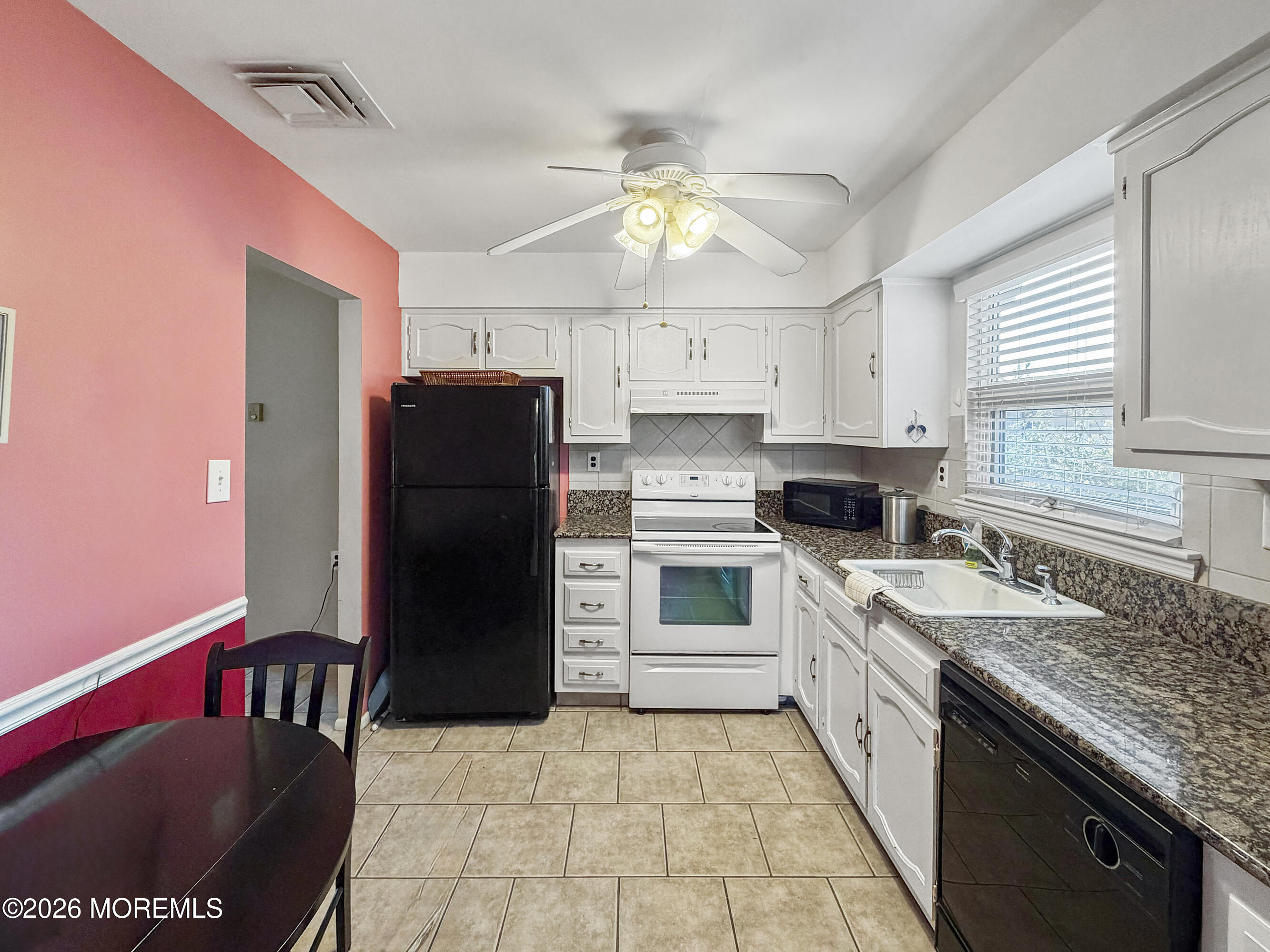 23 Higgins Court Brick, NJ 08724 - Photo 27 of 28 a kitchen with a stove a refrigerator and a sink