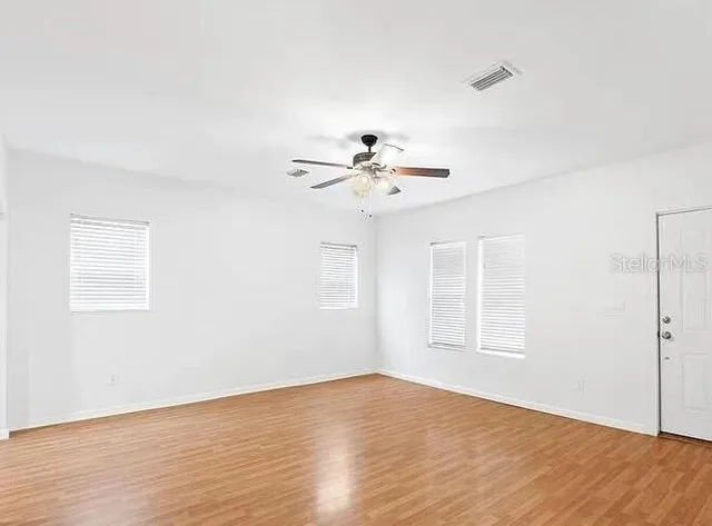wooden floor in an empty room with a window