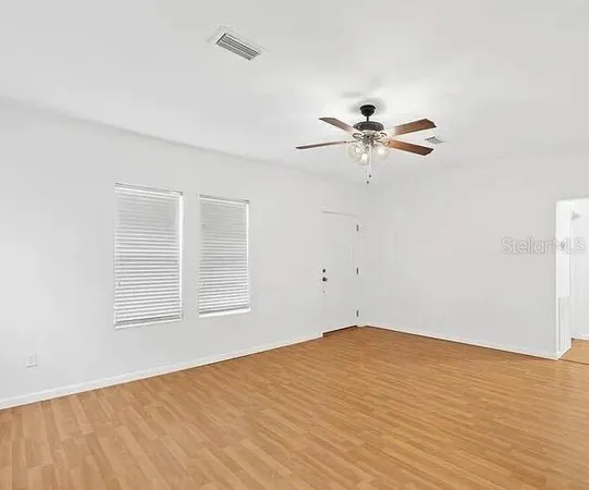 wooden floor in an empty room with a window