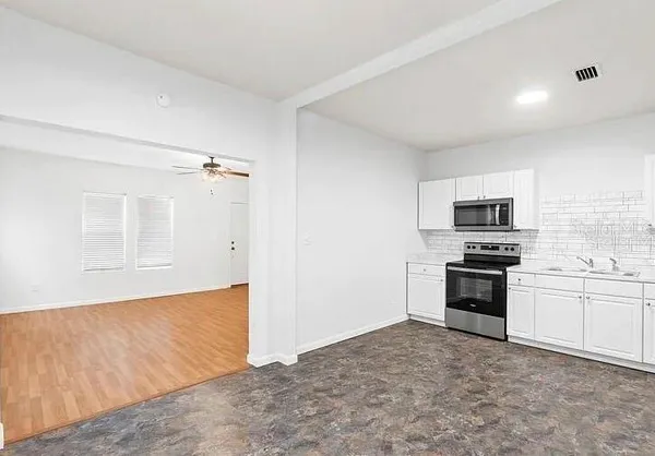 a view of a kitchen with microwave and stove top oven