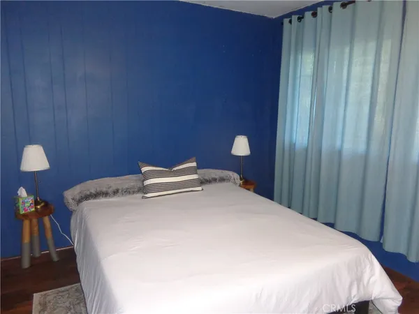 a bed sitting in a bedroom next to a wooden door