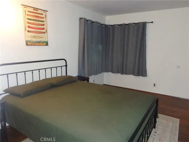 a bed sitting in a bedroom next to a window