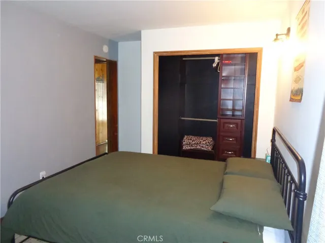 a bedroom with a bed and a mirror