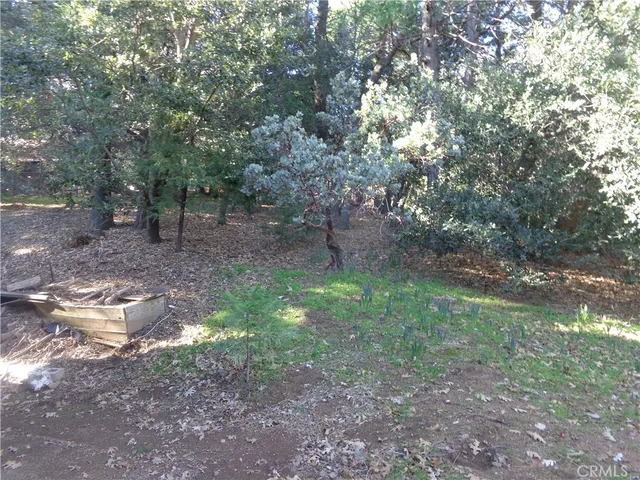 a view of a house with a wooden deck and a chair