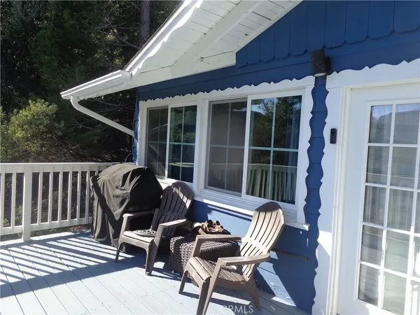a view of a deck with wooden floor and outdoor seating