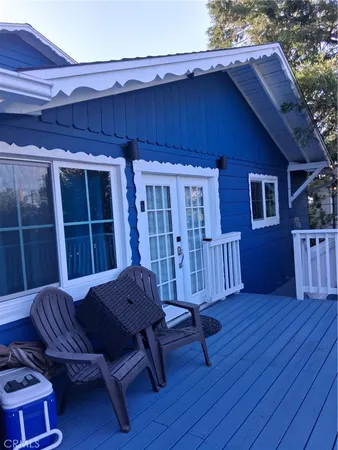 a view of a backyard with wooden floor and outdoor seating