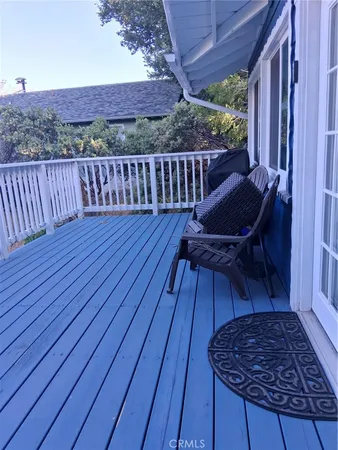 a view of a roof deck with wooden floor and outdoor seating