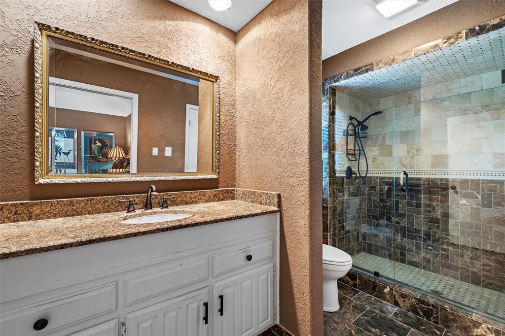 2000 Shadow Ridge Drive Arlington, TX 76006 - Photo 21 of 23 a bathroom with a granite countertop sink mirror and toilet