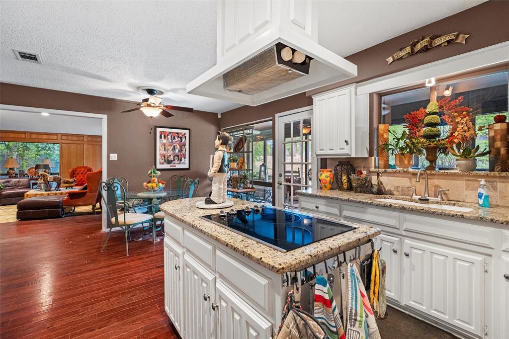 2000 Shadow Ridge Drive Arlington, TX 76006 - Photo 10 of 23 a kitchen that has a lot of cabinets a sink and wooden floor
