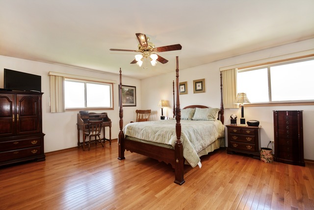 334 Highland Road Matteson, IL 60443 - Photo 7 of 10 a spacious bedroom with a bed and wooden floor