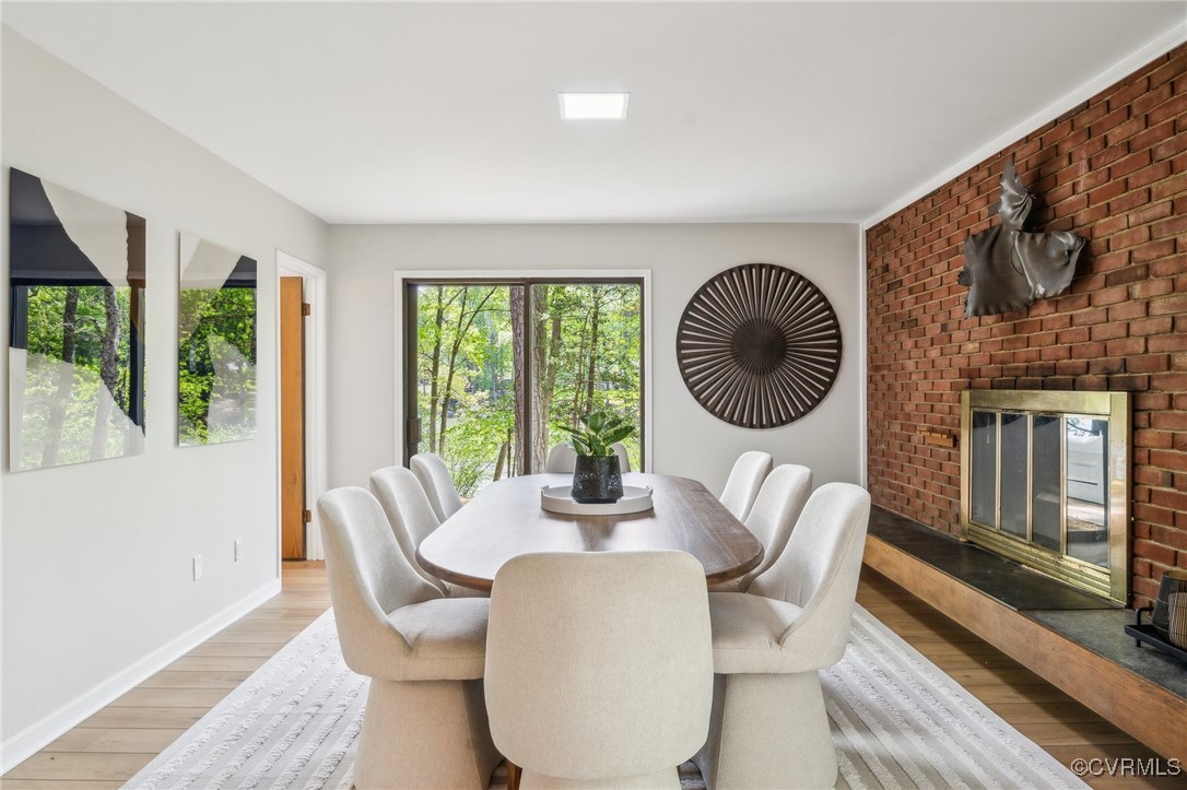 4460 Cheyenne Road Richmond, VA 23235 - Photo 24 of 47 Dining area featuring a fireplace, light wood-styl