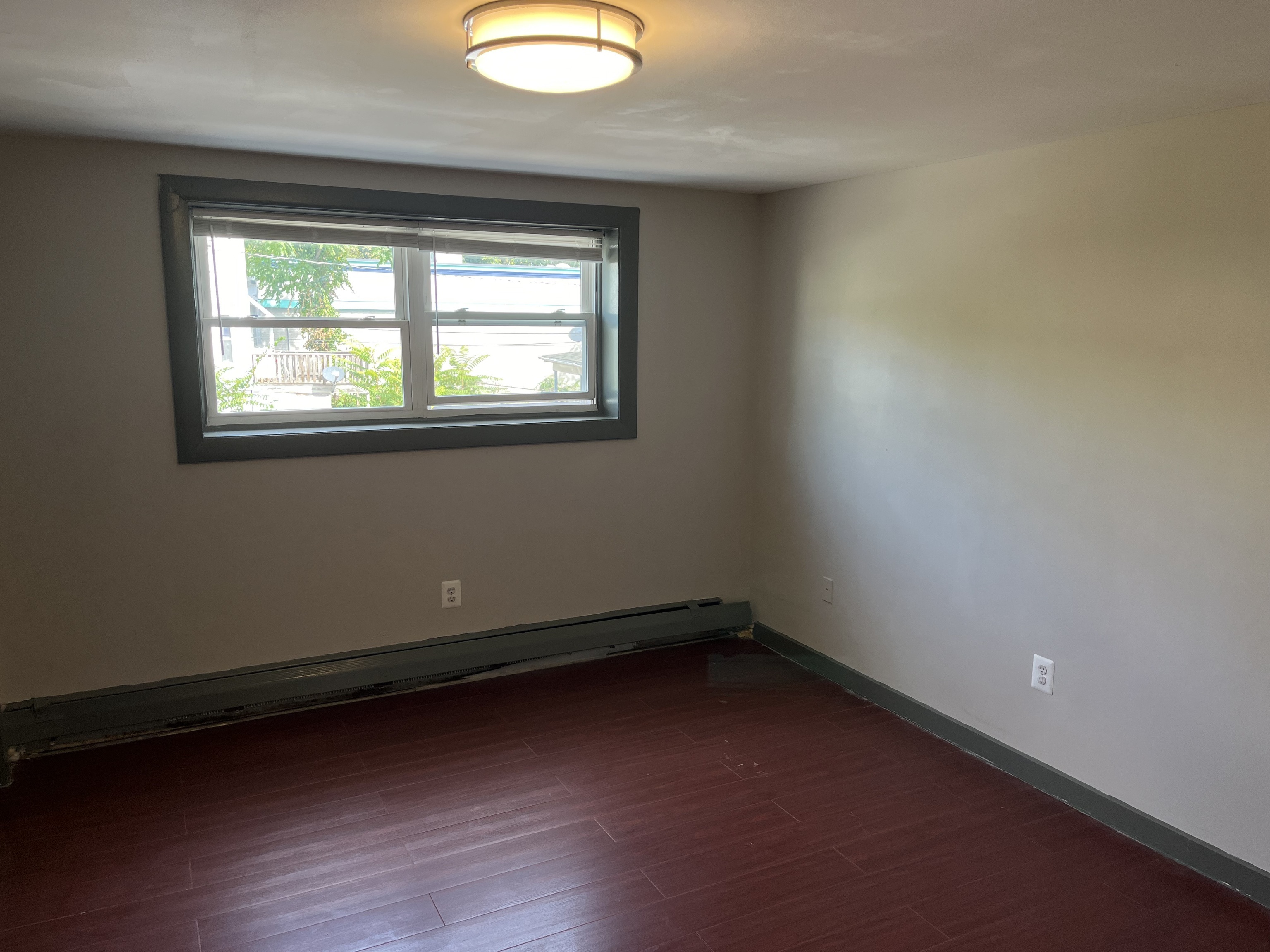 32 Cook Avenue, Unit 209 Meriden, CT 06451 - Photo 5 of 12 an empty room with wooden floor and windows