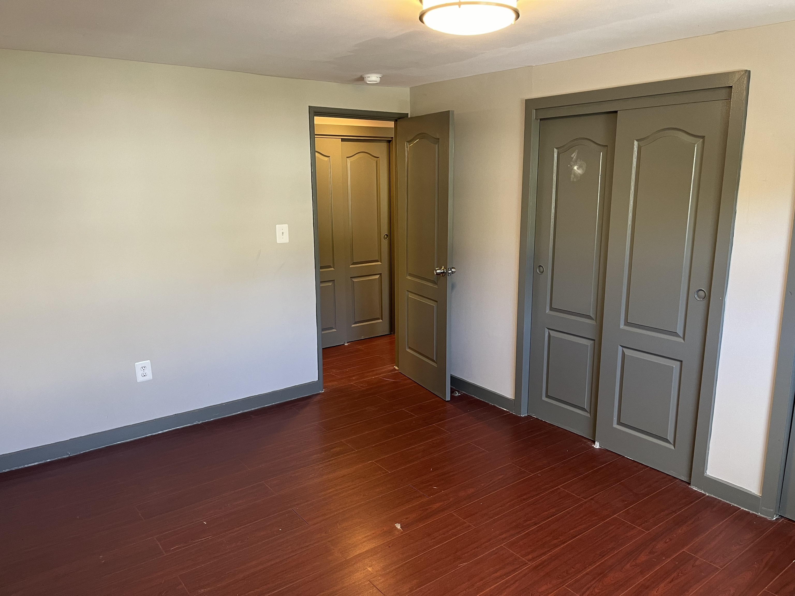 32 Cook Avenue, Unit 209 Meriden, CT 06451 - Photo 6 of 12 an empty room with wooden floor and closet