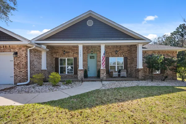 a front view of a house with a garden and yard