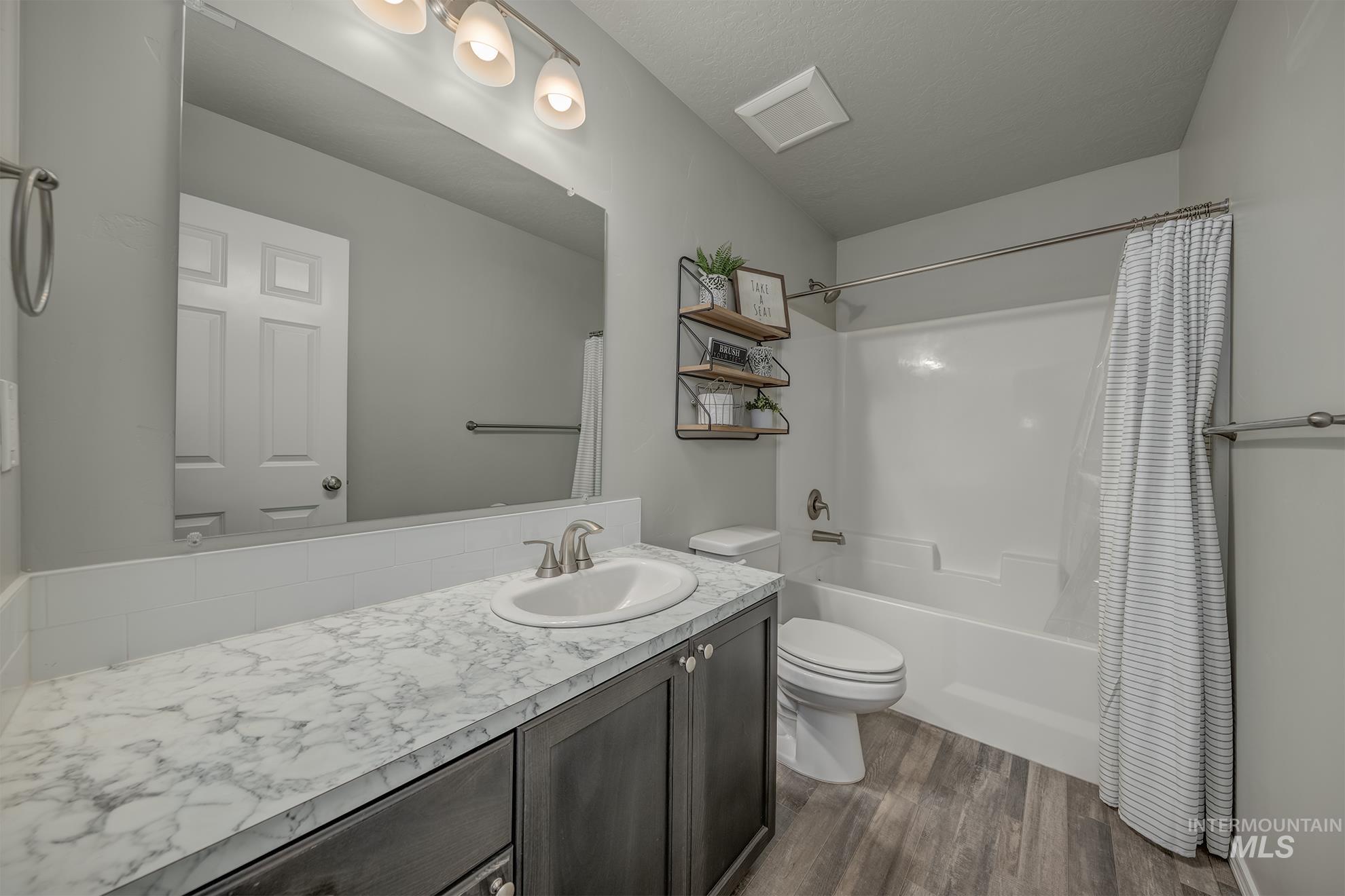 1049 Price Road Weiser, ID 83672 - Photo 28 of 47 Bathroom featuring a single vanity with a white-finish countertop, undermount sink, and brushed nickel faucet