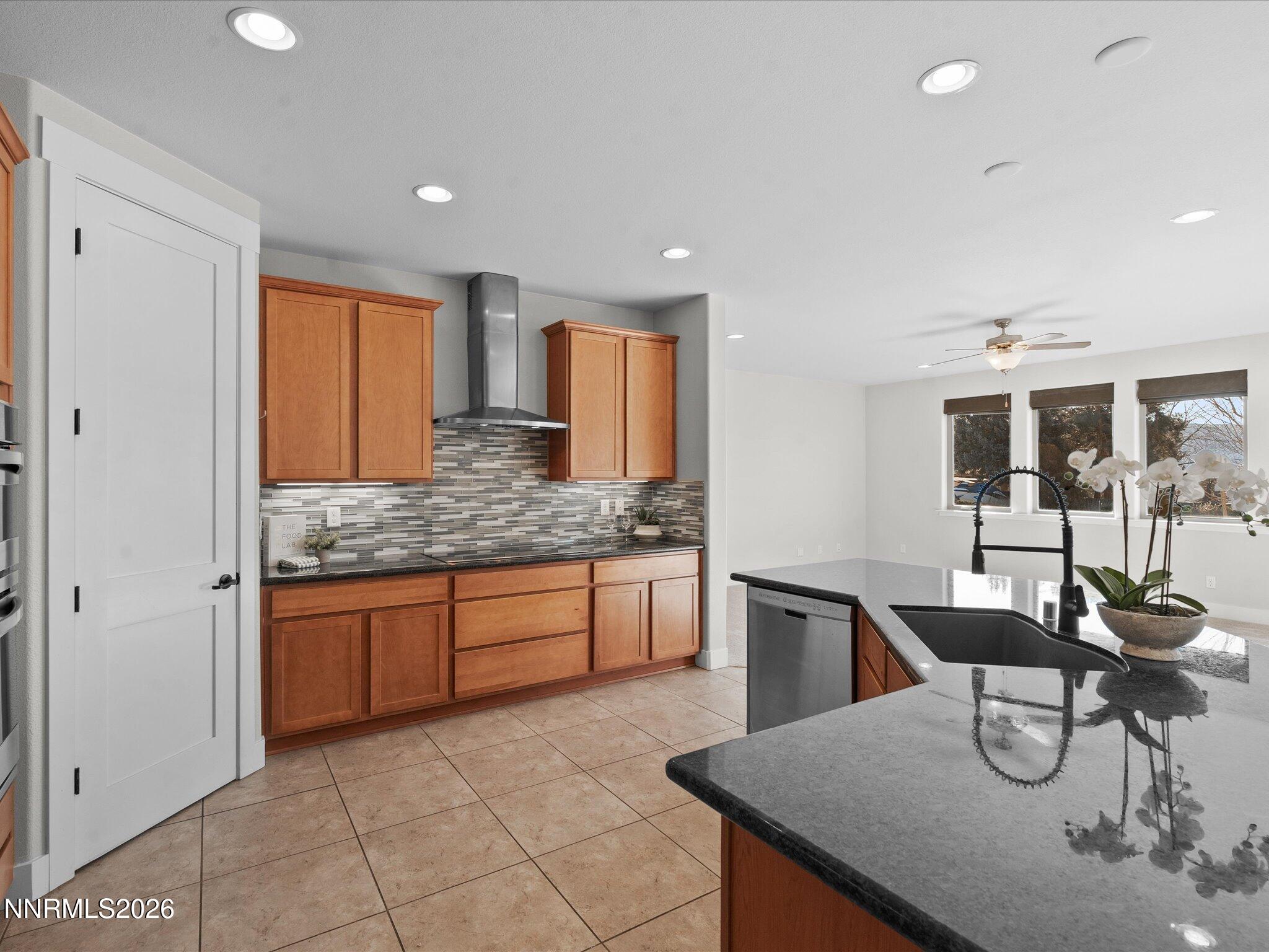 5585 East Hidden Valley Drive Reno, NV 89502 - Photo 11 of 40 a kitchen with granite countertop kitchen island stainless steel appliances a sink and cabinets