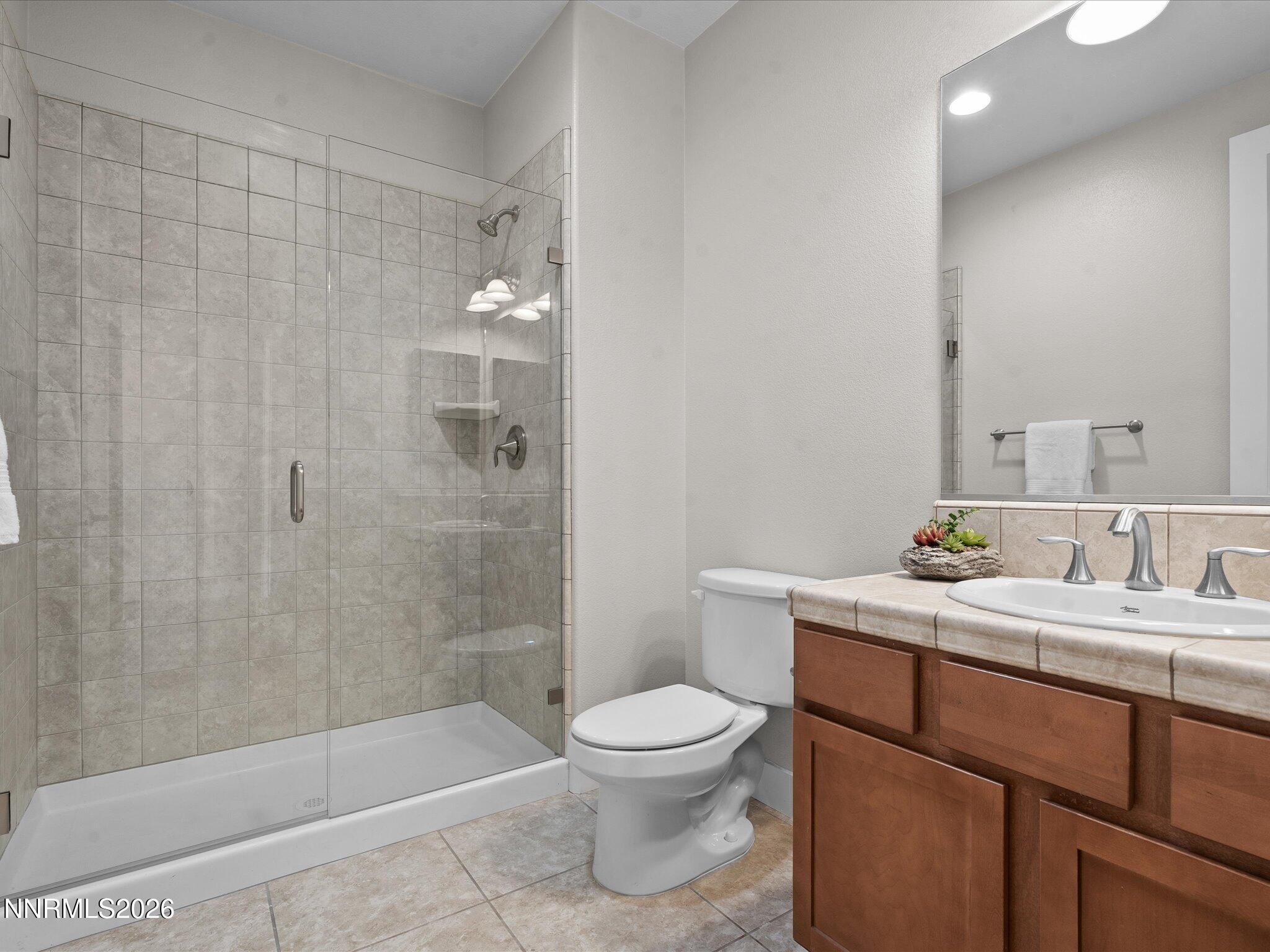 5585 East Hidden Valley Drive Reno, NV 89502 - Photo 24 of 40 a bathroom with a sink a toilet and shower
