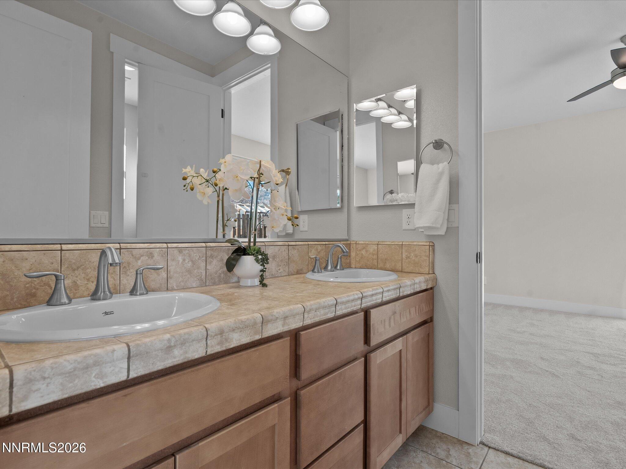 5585 East Hidden Valley Drive Reno, NV 89502 - Photo 26 of 40 a bathroom with a sink and a mirror