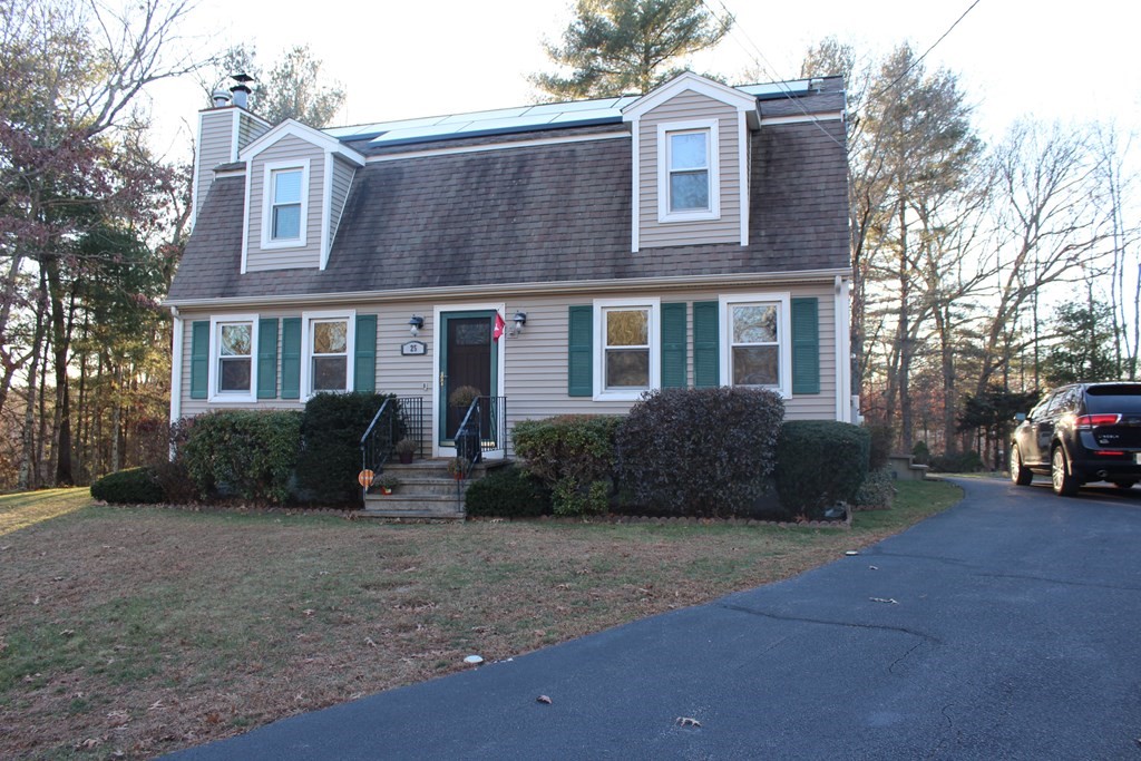 a view of a brick house with many windows and yard