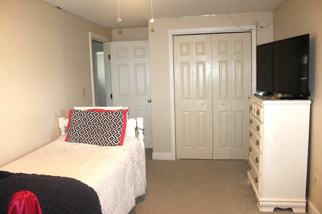 25 3rd Avenue Bellingham, MA 02019 - Photo 11 of 20 a bedroom with a bed and a flat screen tv
