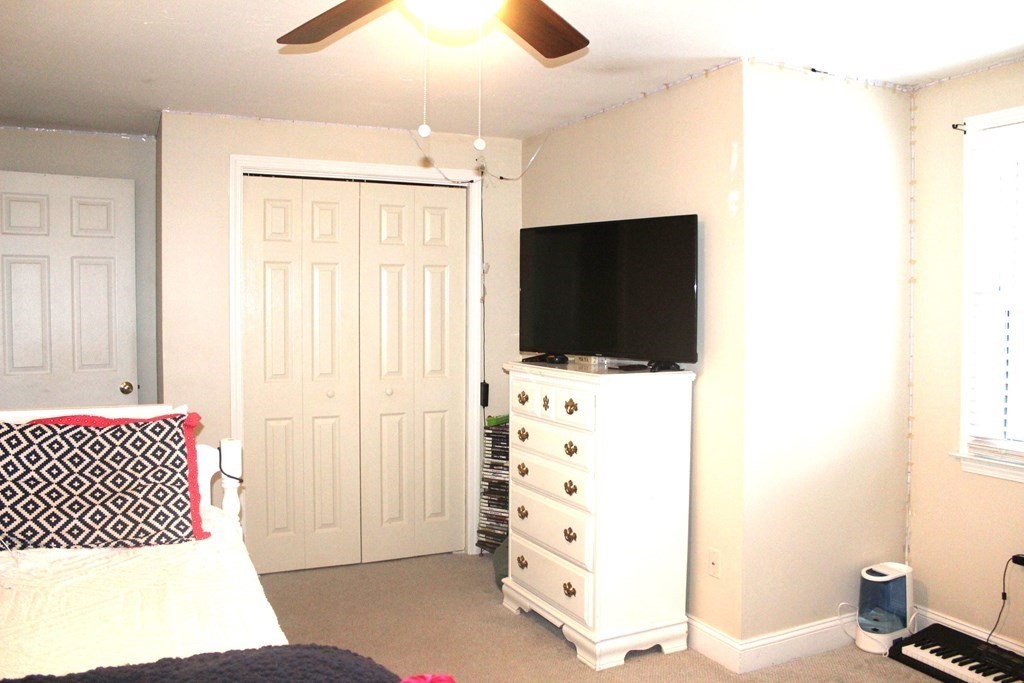 25 3rd Avenue Bellingham, MA 02019 - Photo 12 of 20 a living room with a flat screen tv and a refrigerator