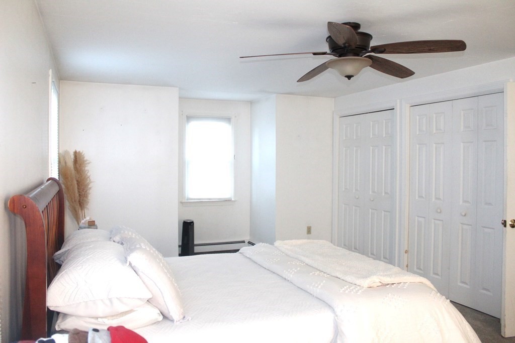 25 3rd Avenue Bellingham, MA 02019 - Photo 18 of 20 a bedroom with a bed and a chandelier