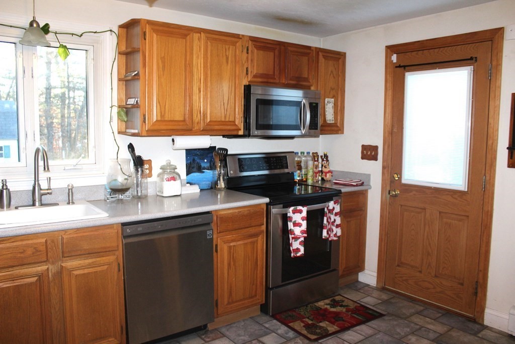 25 3rd Avenue Bellingham, MA 02019 - Photo 2 of 20 a kitchen with stainless steel appliances granite countertop a stove a sink and a microwave