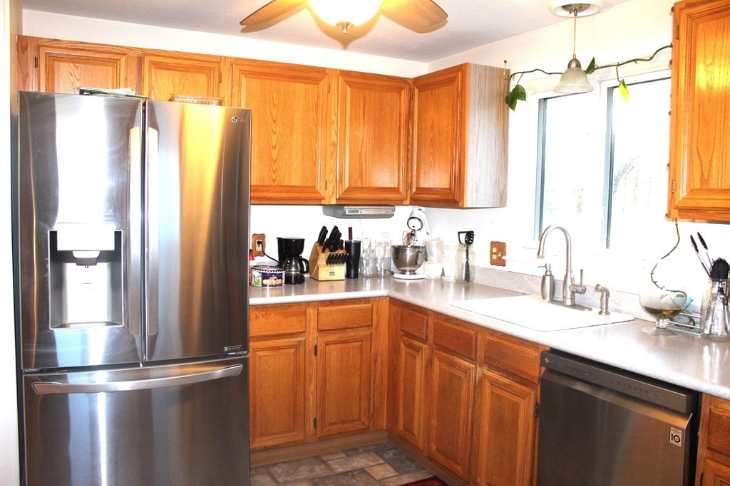 25 3rd Avenue Bellingham, MA 02019 - Photo 3 of 20 a kitchen with stainless steel appliances a refrigerator sink and cabinets