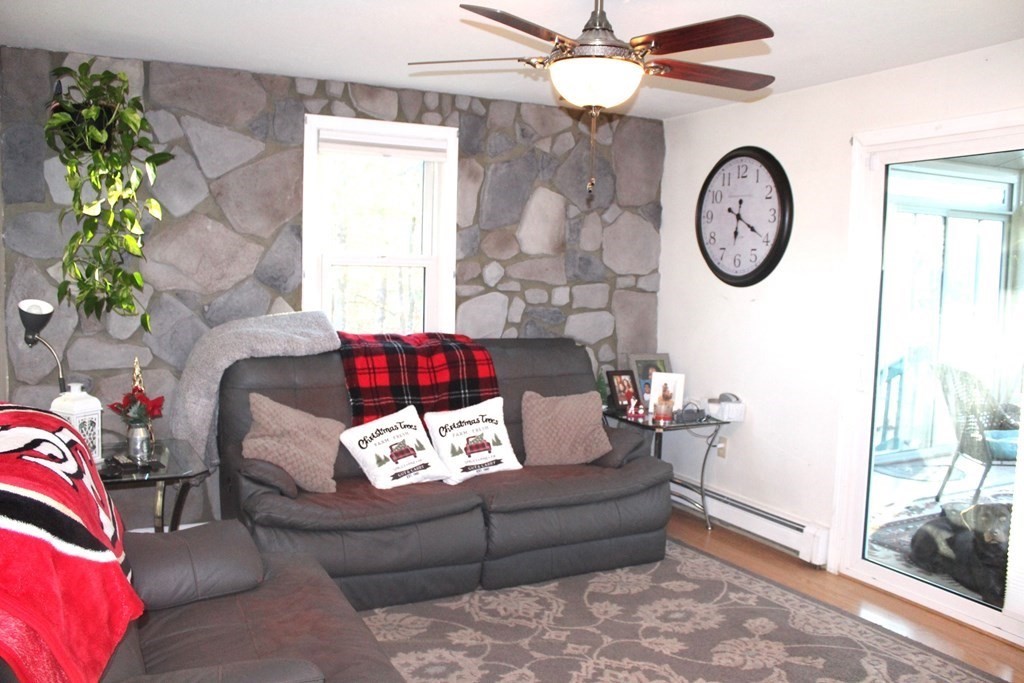 25 3rd Avenue Bellingham, MA 02019 - Photo 8 of 20 a living room with furniture a clock and a rug