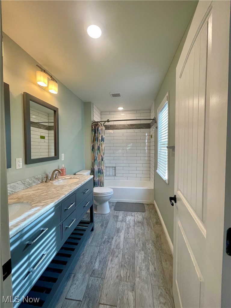 1544 Edgefield Road Lyndhurst, OH 44124 - Photo 36 of 36 Full bathroom featuring shower / bath combo, double vanity, dark wood-style flooring, and recessed lighting