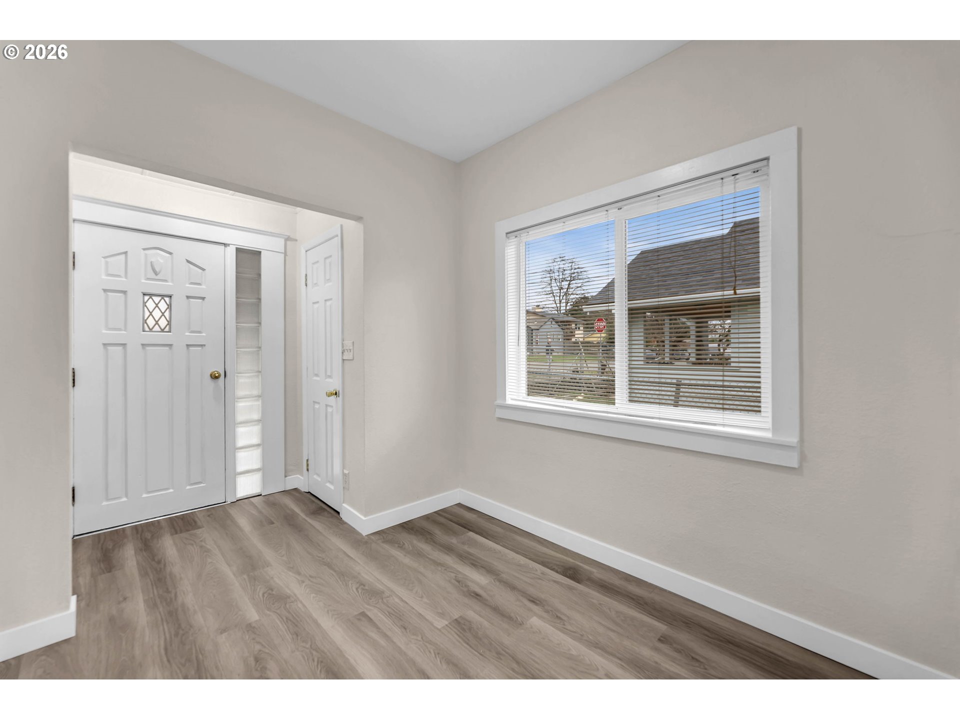 647 Southeast Russell Street Camas, WA 98607 - Photo 3 of 21 a view of an empty room with wooden floor and a window