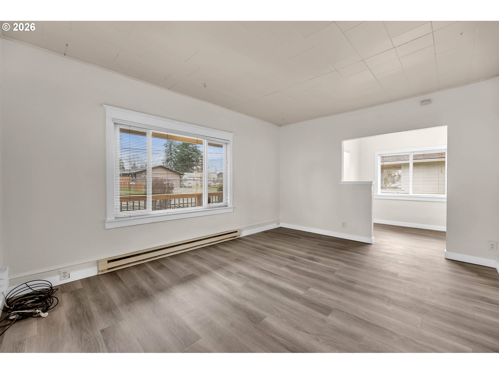 647 Southeast Russell Street Camas, WA 98607 - Photo 5 of 21 an empty room with wooden floor and windows