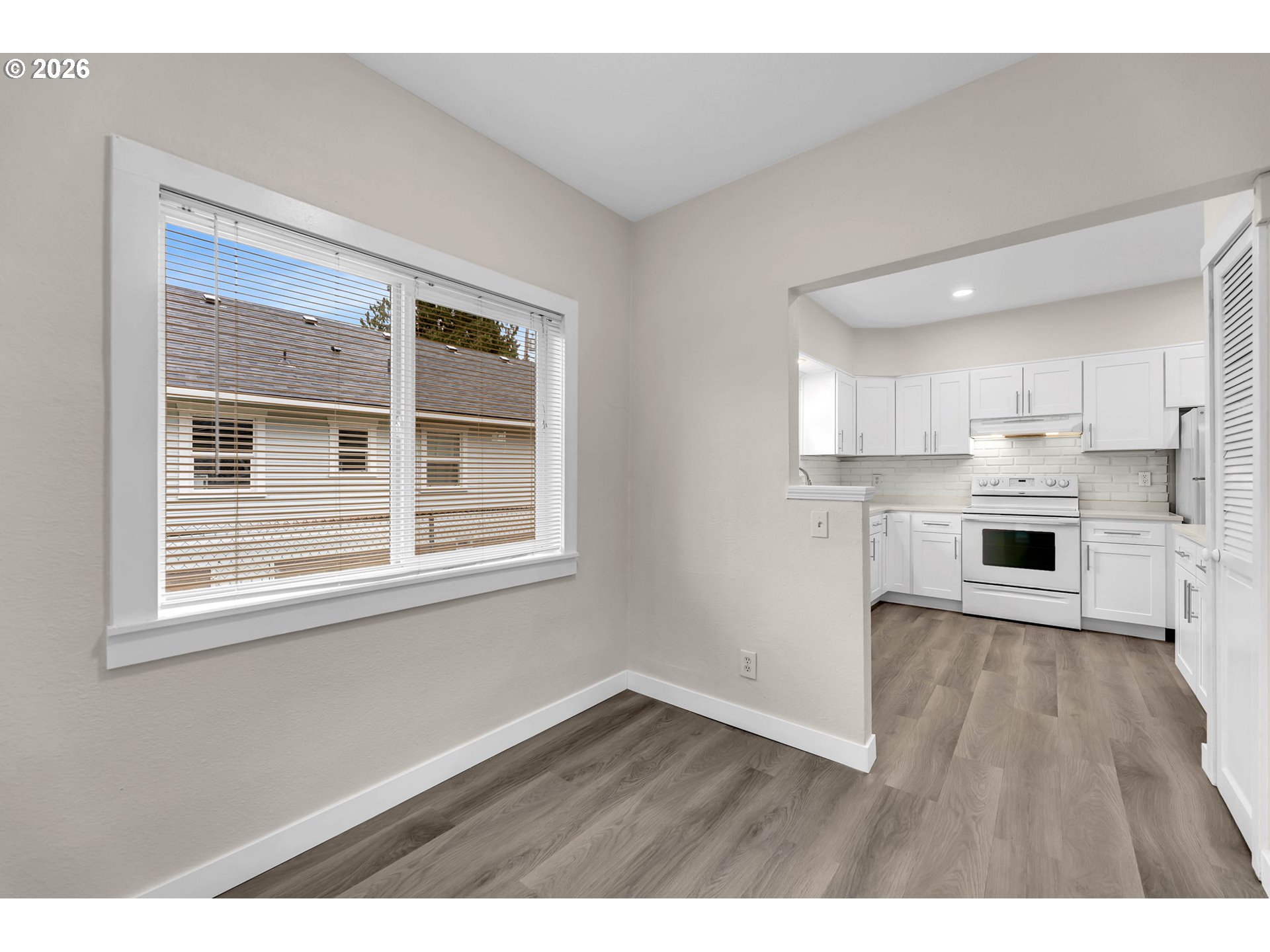 647 Southeast Russell Street Camas, WA 98607 - Photo 6 of 21 a view of an empty room with wooden floor and a window