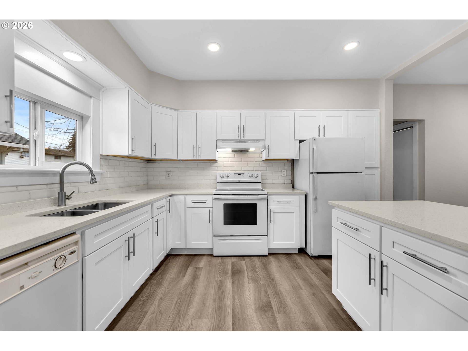 647 Southeast Russell Street Camas, WA 98607 - Photo 7 of 21 a kitchen with a white cabinets and wooden floor