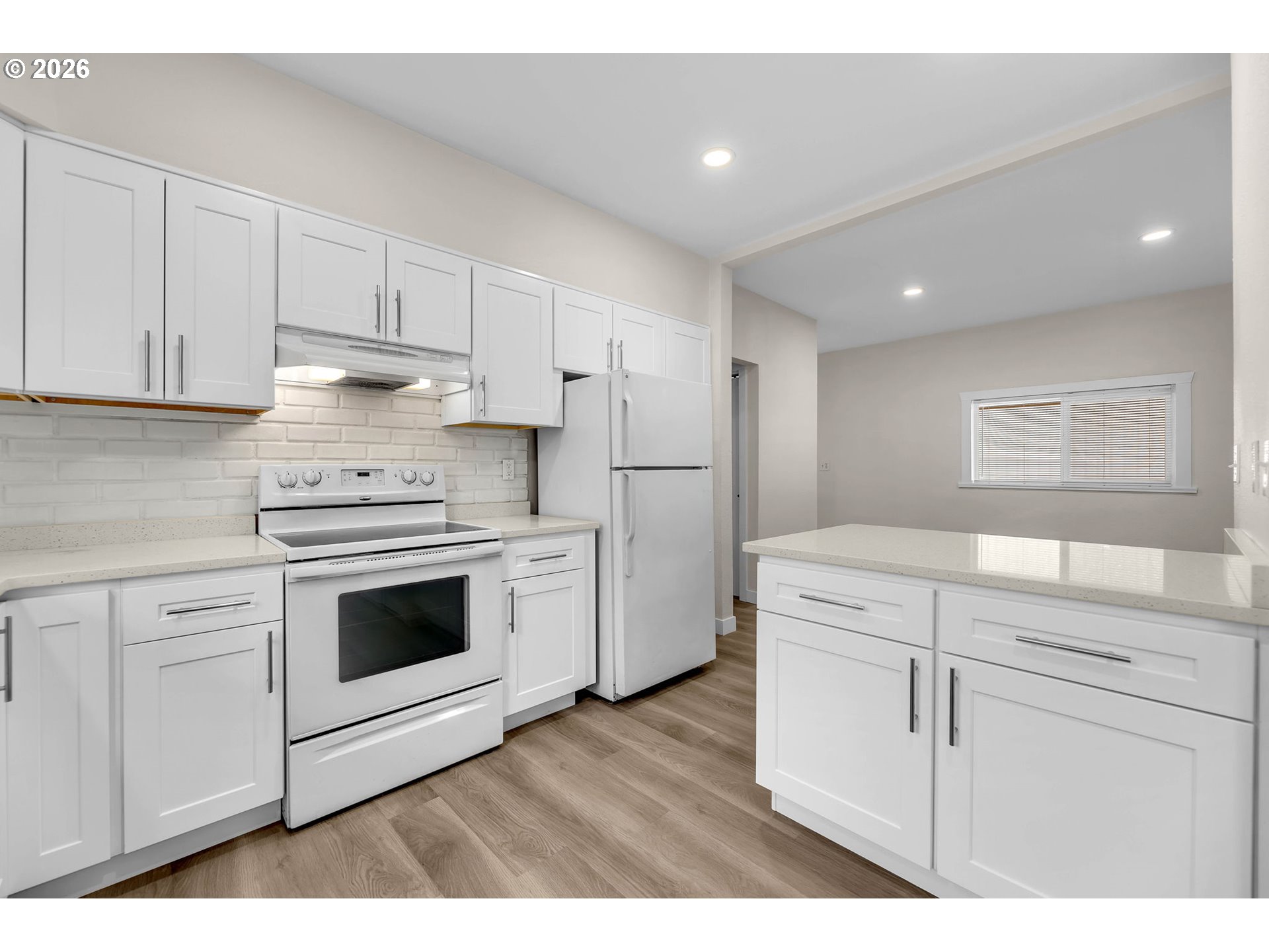 647 Southeast Russell Street Camas, WA 98607 - Photo 9 of 21 a kitchen with white cabinets and white appliances