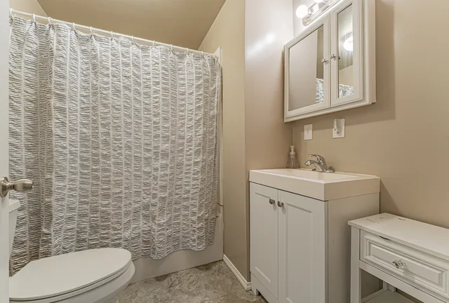 a bathroom with a sink a toilet and a mirror