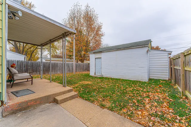 a backyard of a house with garden and patio