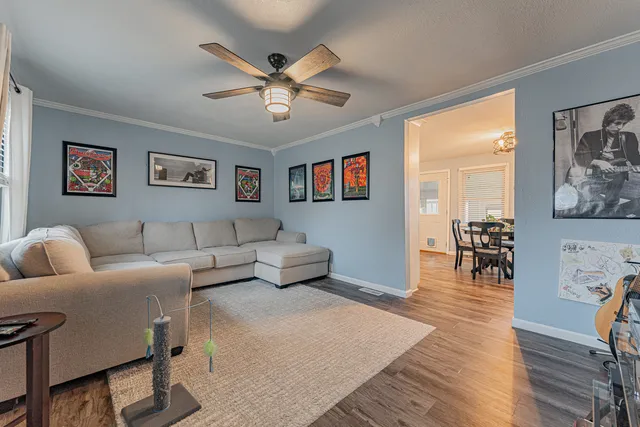 a living room with furniture and wooden floor