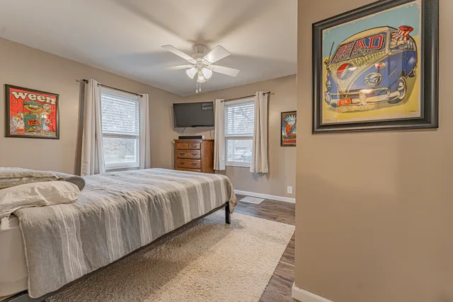 a bedroom with a bed and a painting on the wall