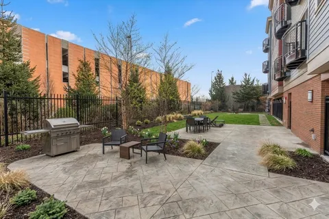 a view of a patio with couches table and chairs and potted plants