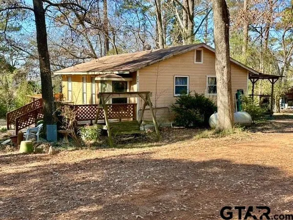 a view of a house with yard and sitting area