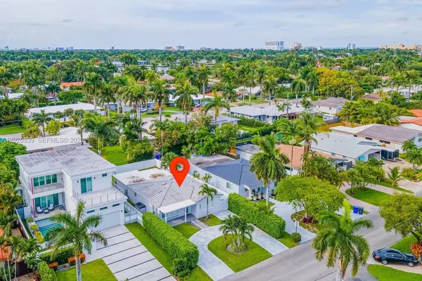 an aerial view of a house with garden space and street view