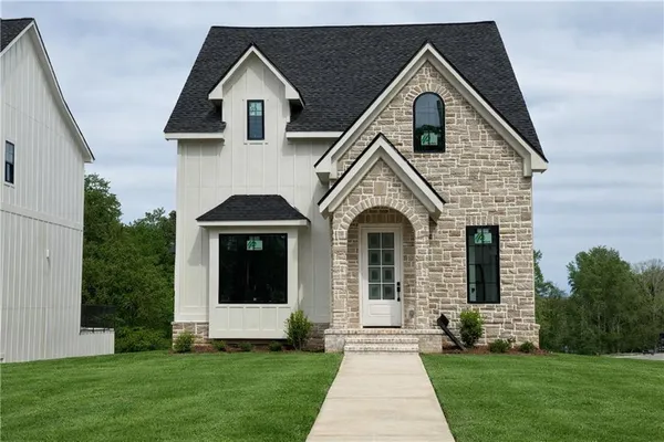 a front view of a house with a yard