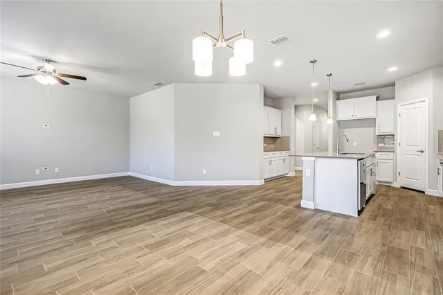 a view of kitchen and hall with wooden floor