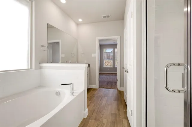 a bathroom with a bathtub a sink and a shower