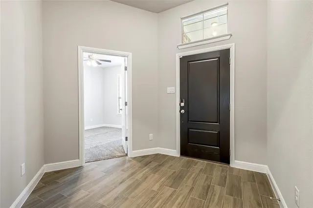 an empty room with wooden floor cabinet and closet