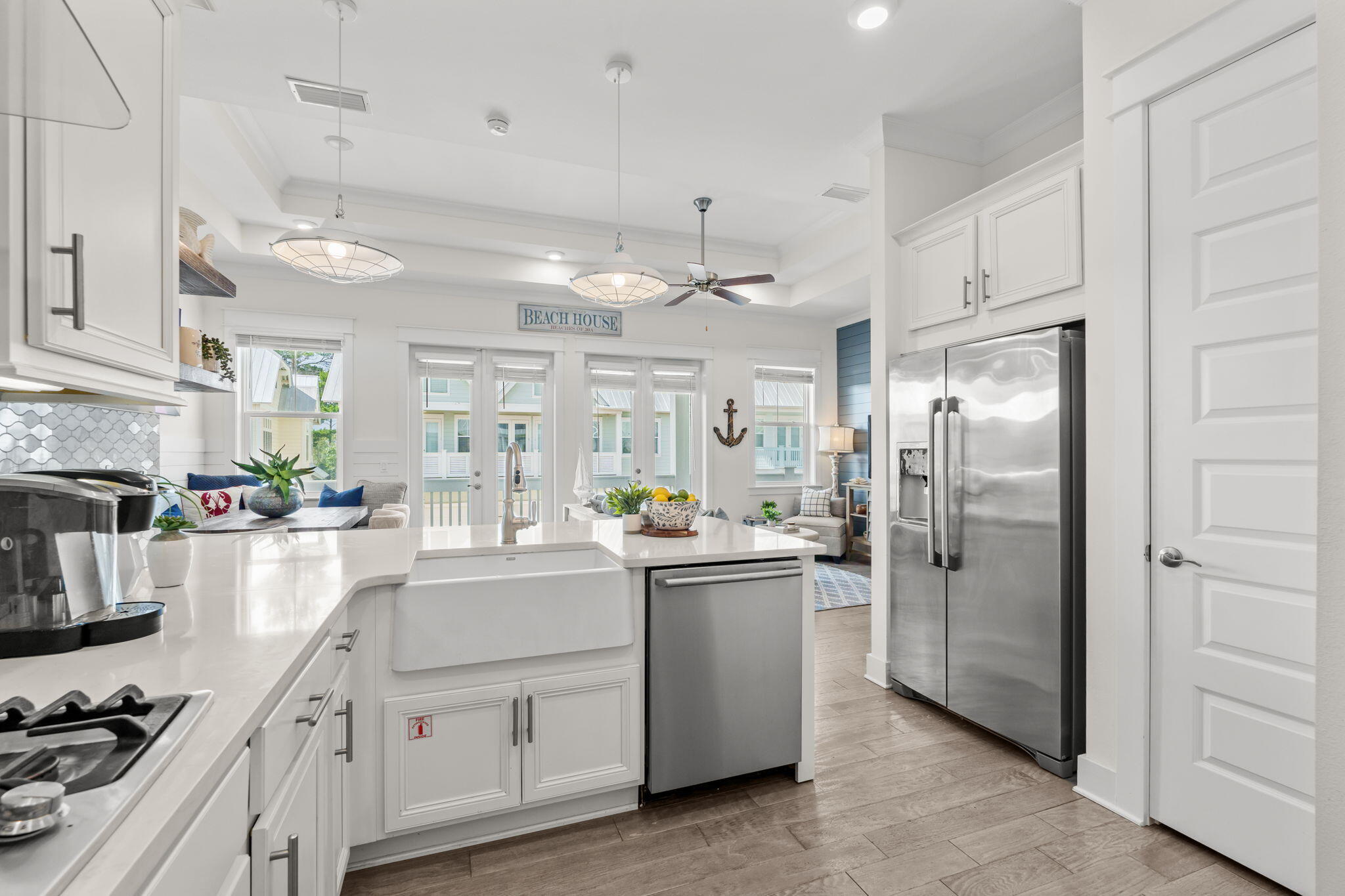 268 Milestone Dr Inlet Beach, Unit C Inlet Beach, FL 32461 - Photo 10 of 34 a kitchen with stainless steel appliances kitchen island granite countertop a refrigerator a sink a stove and white cabinets