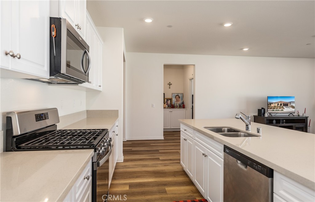 19778 Limon Court Riverside, CA 92507 - Photo 9 of 26 a kitchen with stainless steel appliances granite countertop a stove a sink and a microwave