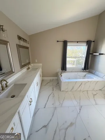 a bathroom with a sink and mirror