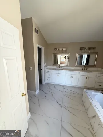 a large white kitchen with a sink
